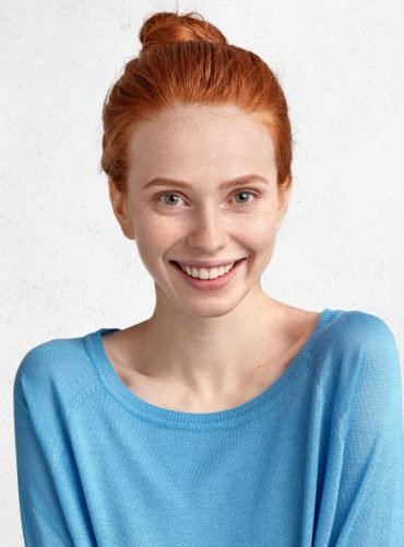 cheerful-delighted-female-with-red-hair-tied-in-kn-7VGXYFD.jpg